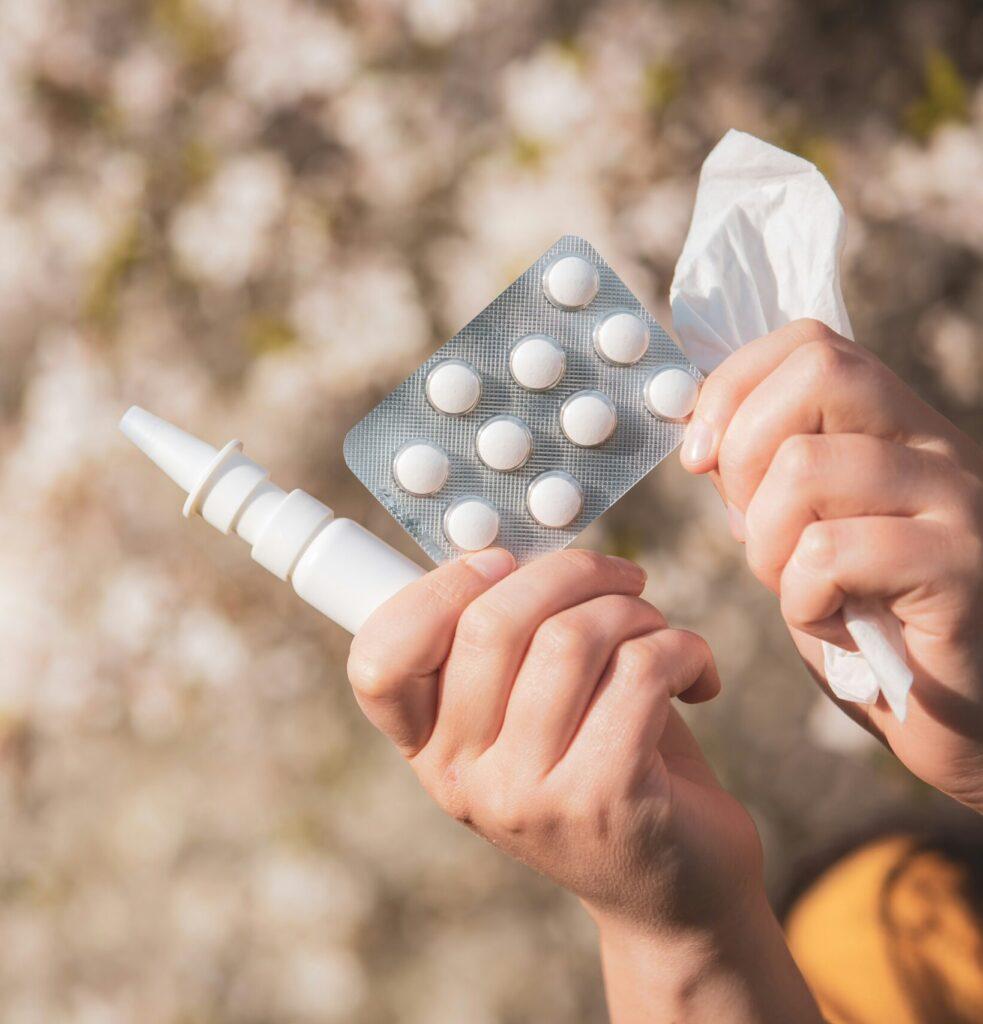 a person holding a pack of pills in their hand
