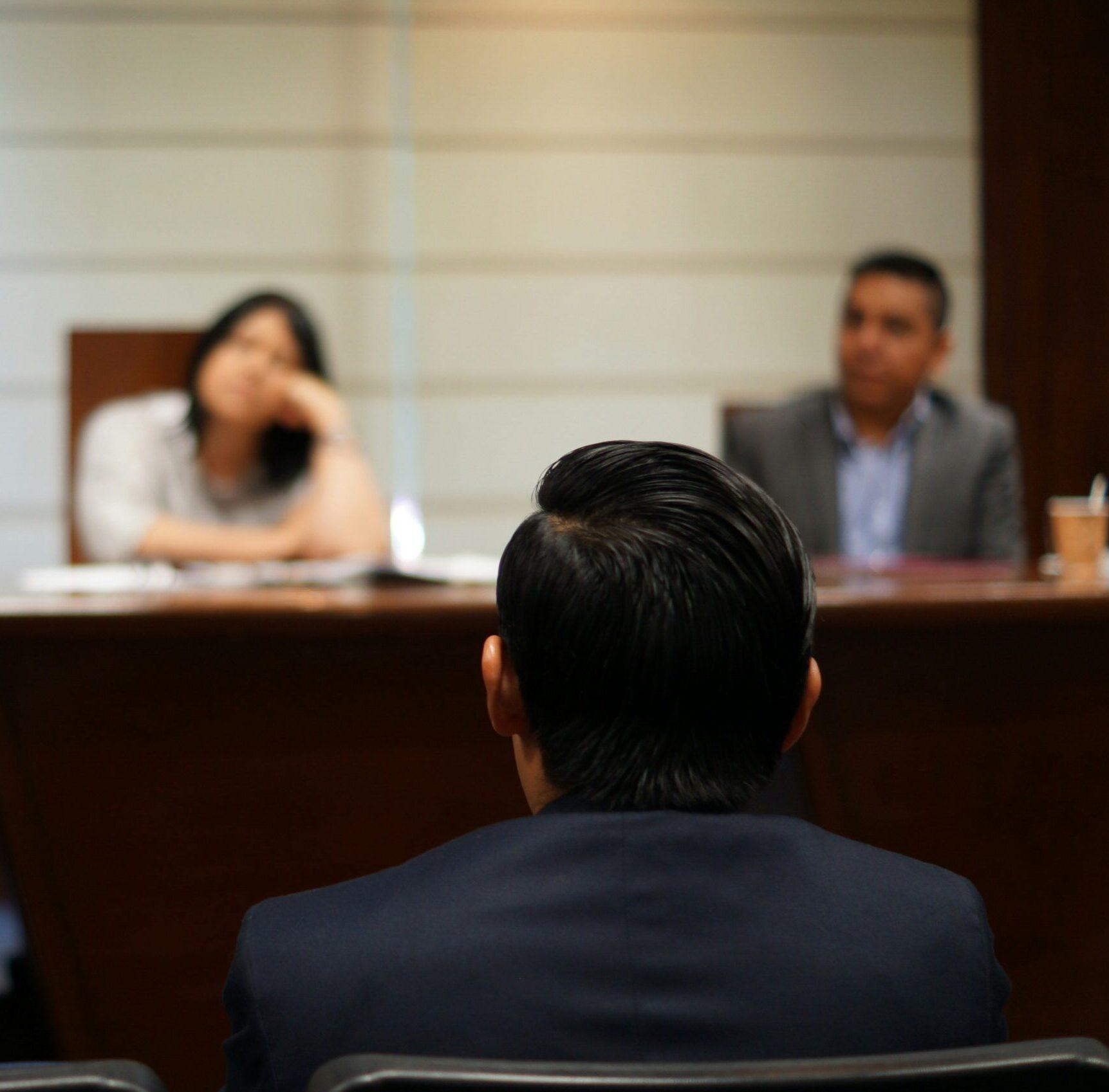 man in black shirt sitting beside woman in white shirt