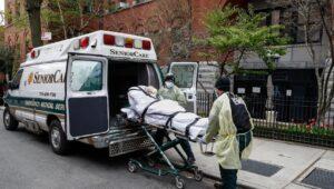 Patient on a gurney being loaded onto an ambulance for transport