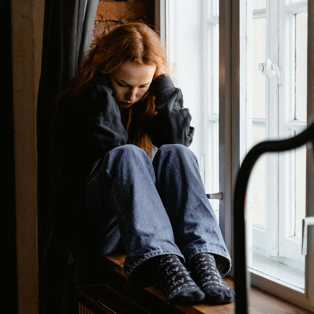 person sitting by a window