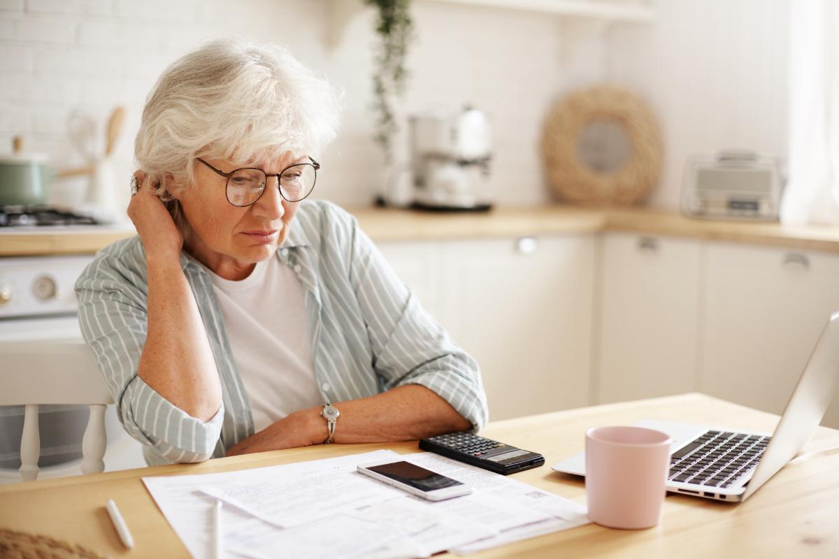 Elderly woman worrying about her finances. How to prove financial exploitation for nursing home residents.