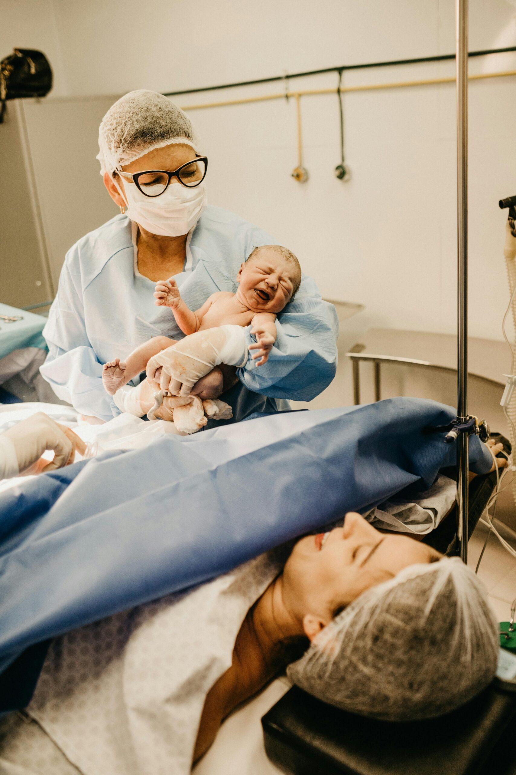nurse holding a newborn baby