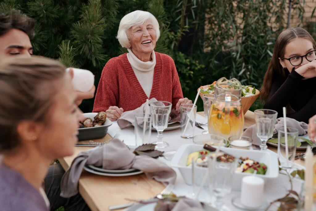 happy elderly woman surrounded by family