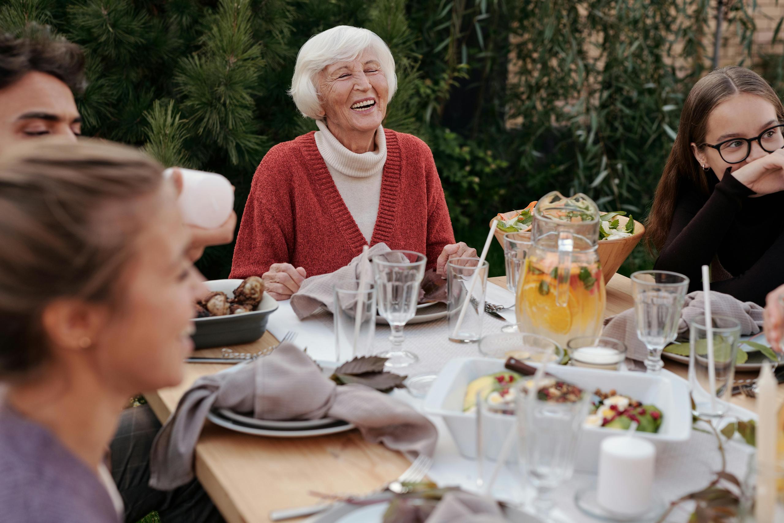 happy elderly woman surrounded by family