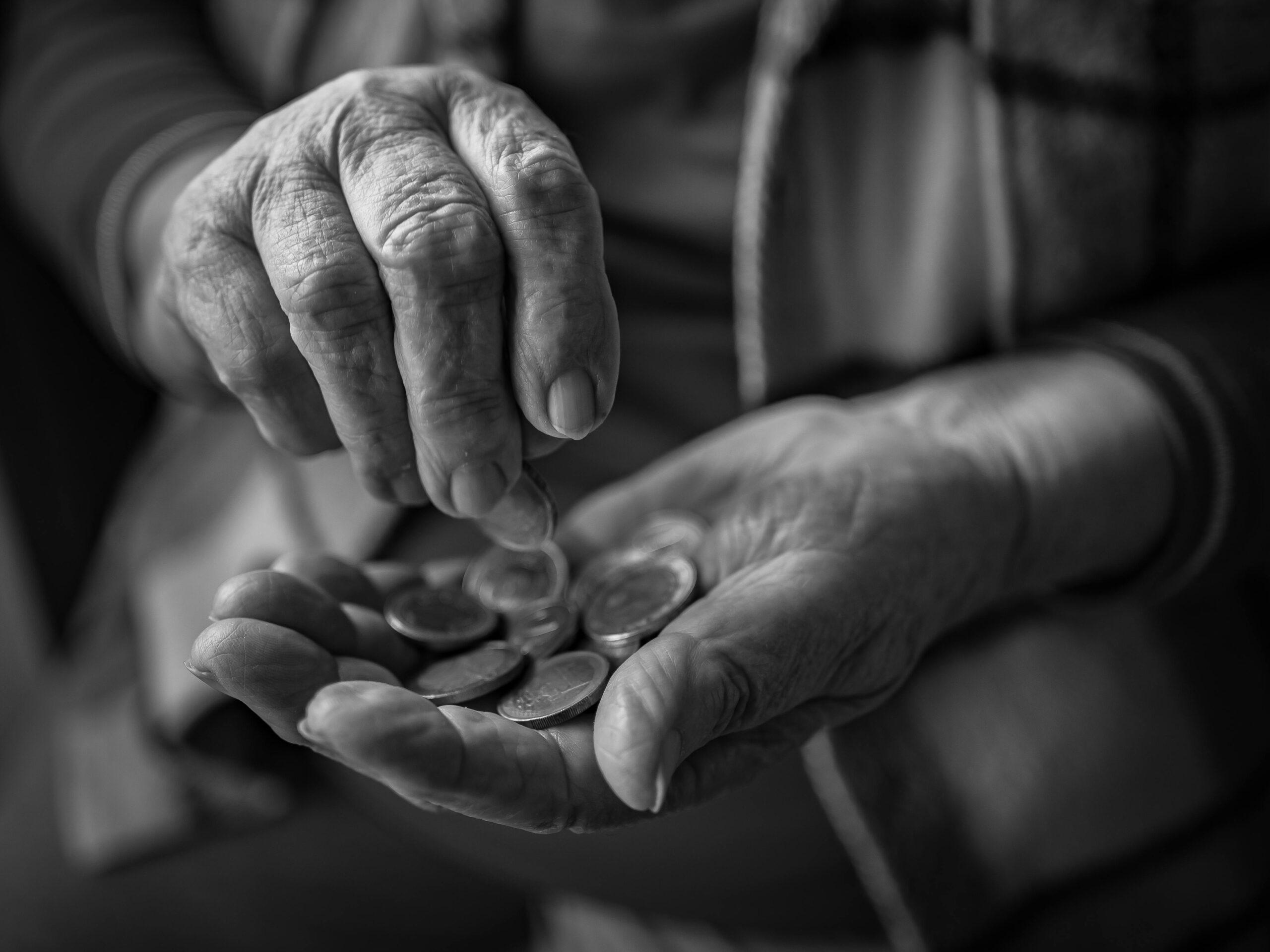 elderly hands holding coins