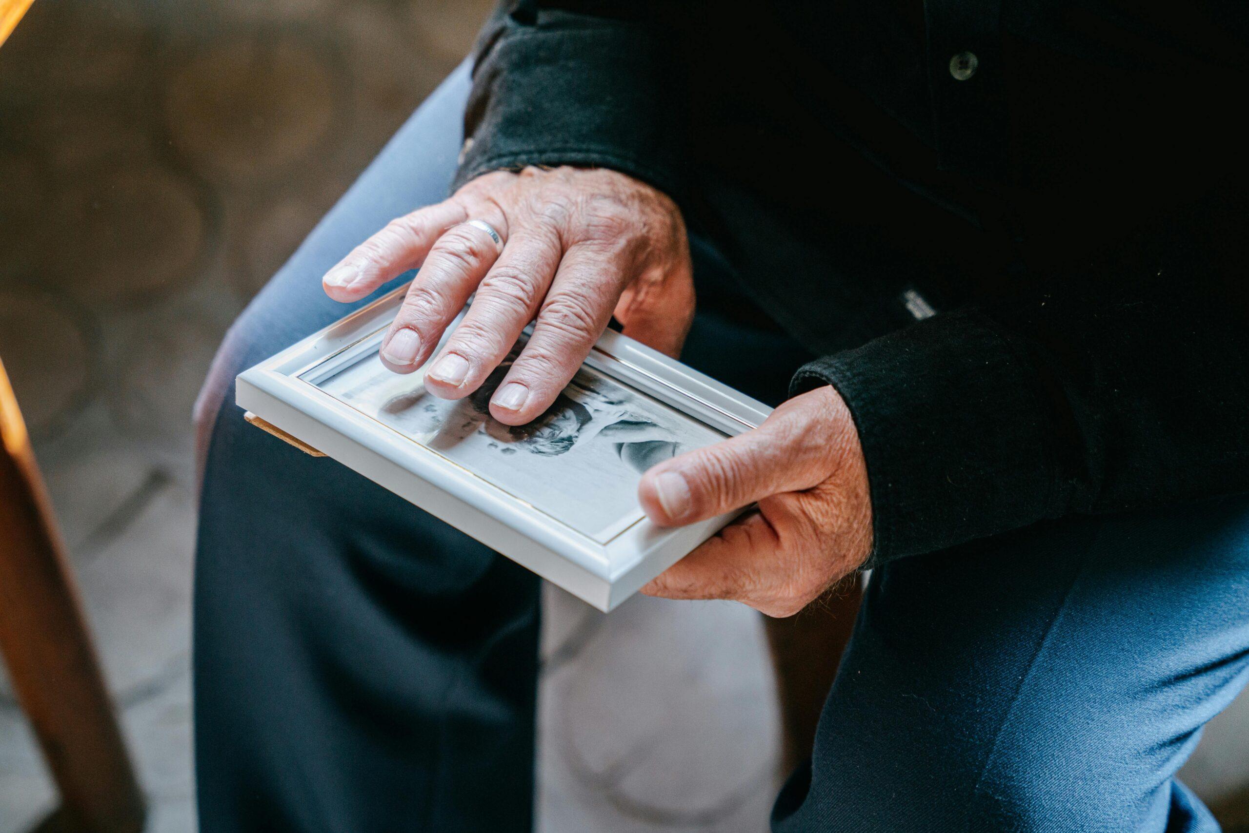 elderly person holding a photo