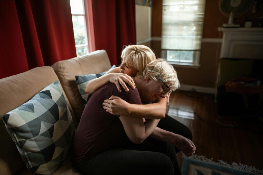 elderly woman being consoled